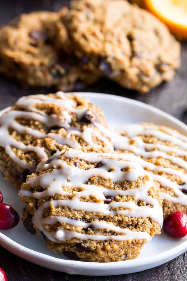 These cranberry orange chewy chocolate chip cookies might just become your favorite cookies, ever!  They're grain free yet have a thick and chewy "oatmeal" texture, and are also egg free, dairy free, paleo and vegan.  Super kid friendly and perfect for the holidays or anytime!