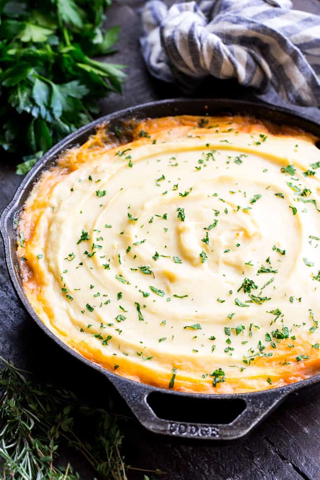This Shepherd's Pie is classic, cozy comfort food for cold winter days!  It's paleo and Whole30 compliant, dairy free and kid approved.  A flavorful, hearty ground beef mixture is topped with creamy dairy-free mashed potatoes, and baked until golden brown and bubbling.  