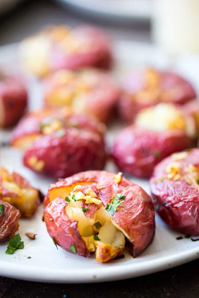 These garlic smashed potatoes are crispy on the outside, soft inside, and full of flavor! Top them or dip them in an easy 2 minute (YES!) homemade aioli that's Whole30 compliant and paleo!  Dairy free, gluten free, family approved!