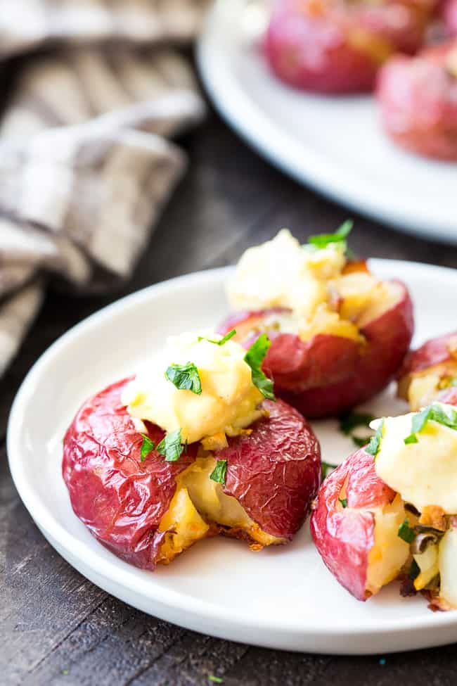 These garlic smashed potatoes are crispy on the outside, soft inside, and full of flavor! Top them or dip them in an easy 2 minute (YES!) homemade aioli that's Whole30 compliant and paleo!  Dairy free, gluten free, family approved!