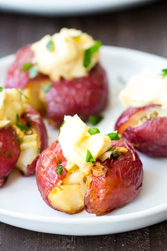 These garlic smashed potatoes are crispy on the outside, soft inside, and full of flavor! Top them or dip them in an easy 2 minute (YES!) homemade aioli that's Whole30 compliant and paleo!  Dairy free, gluten free, family approved!