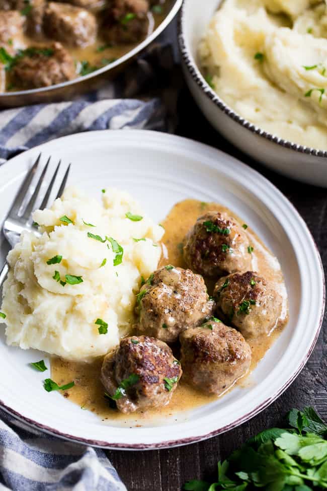 These Paleo Swedish meatballs in a creamy gravy, with dairy-free, Whole30 friendly mashed potatoes is pure comfort food for cold nights.  Made with real-food ingredients, gluten-free, dairy-free, family approved!