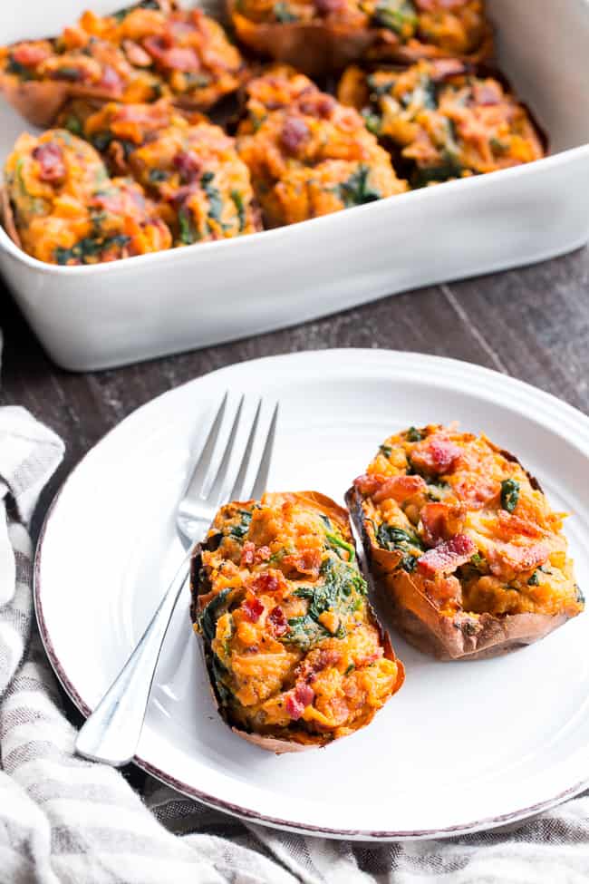 These twice baked sweet potatoes can be served as a healthy meal or side dish - your choice!  They're packed with a savory mixture of caramelized onions, spinach and bacon and baked to perfection.  They're family approved, Paleo, Whole30 compliant, and dairy-free.  