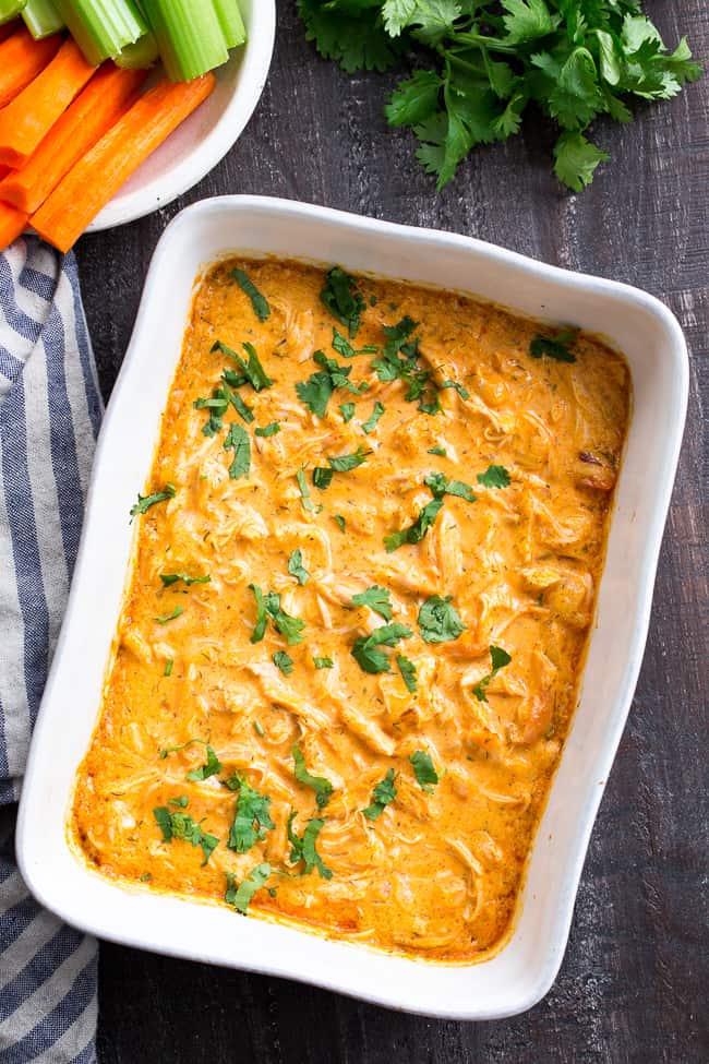 Perfectly creamy and packed with spice and flavor, this buffalo chicken dip is so ridiculously tasty that you'd never guess it's Paleo, Whole30 compliant, dairy-free, and keto friendly!  Use as a dip for veggies, tostones, or as a topping for sweet potato toast or a baked potato to make it a full meal!