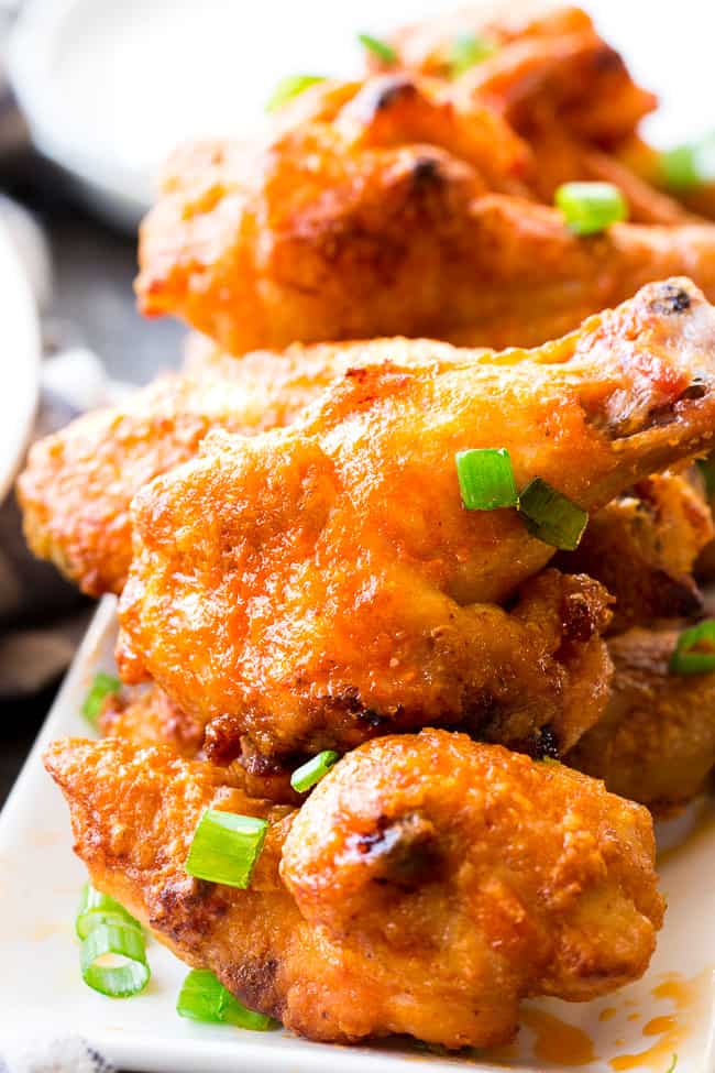 These crispy baked buffalo chicken wings are easy to make, healthy, and ridiculously tasty!   They're  paleo and Whole30 compliant and perfect with Whole30 homemade ranch dip. Perfect as a healthy appetizer, Super Bowl snack or with a salad for dinner! #Whole30 #Paleo 