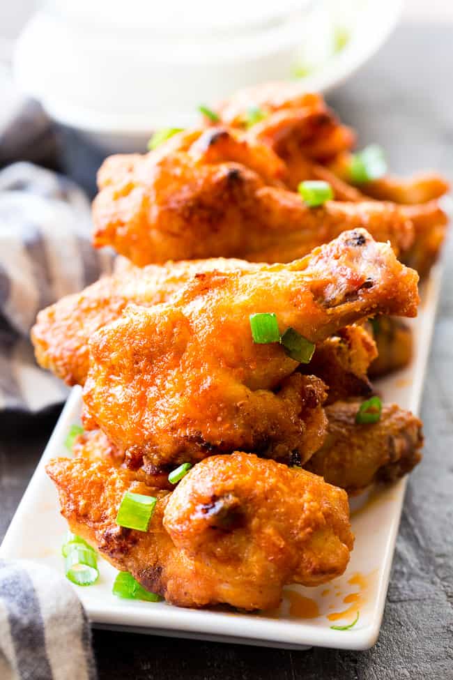 These crispy baked buffalo chicken wings are easy to make, healthy, and ridiculously tasty!   They're  paleo and Whole30 compliant and perfect with Whole30 homemade ranch dip. Perfect as a healthy appetizer, Super Bowl snack or with a salad for dinner! #Whole30 #Paleo 