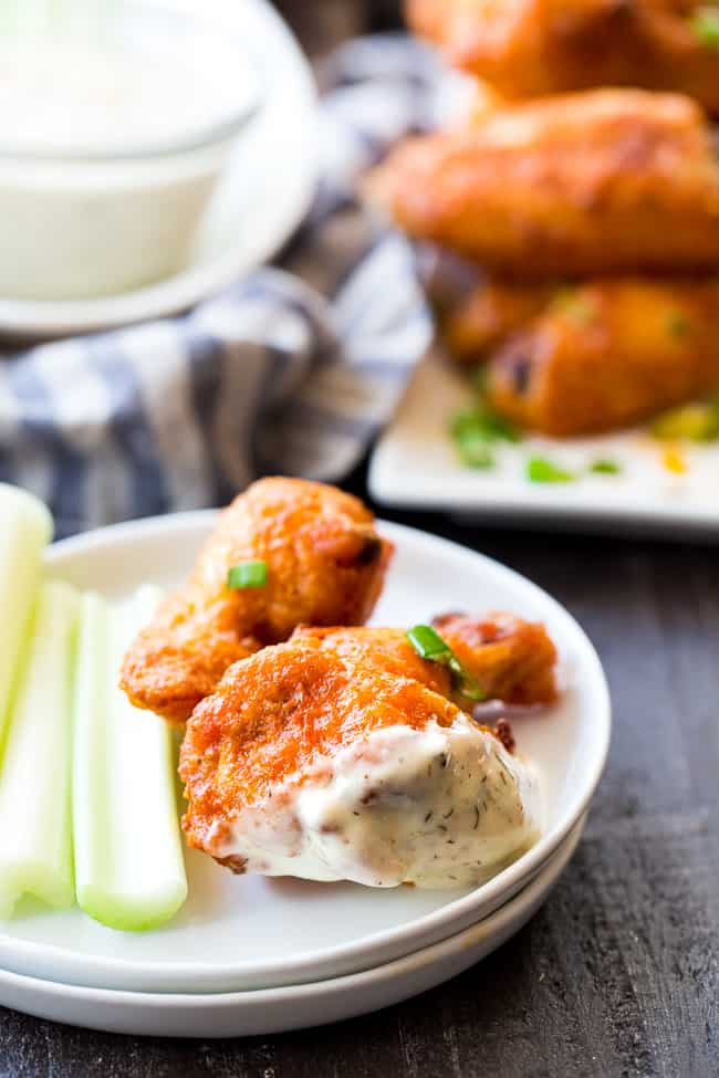 These crispy baked buffalo chicken wings are easy to make, healthy, and ridiculously tasty!   They're  paleo and Whole30 compliant and perfect with Whole30 homemade ranch dip. Perfect as a healthy appetizer, Super Bowl snack or with a salad for dinner! #Whole30 #Paleo 