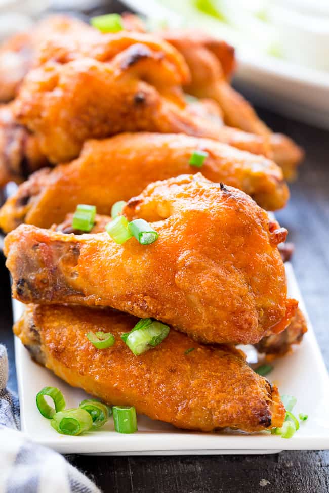 These crispy baked buffalo chicken wings are easy to make, healthy, and ridiculously tasty!   They're  paleo and Whole30 compliant and perfect with Whole30 homemade ranch dip. Perfect as a healthy appetizer, Super Bowl snack or with a salad for dinner! #Whole30 #Paleo 