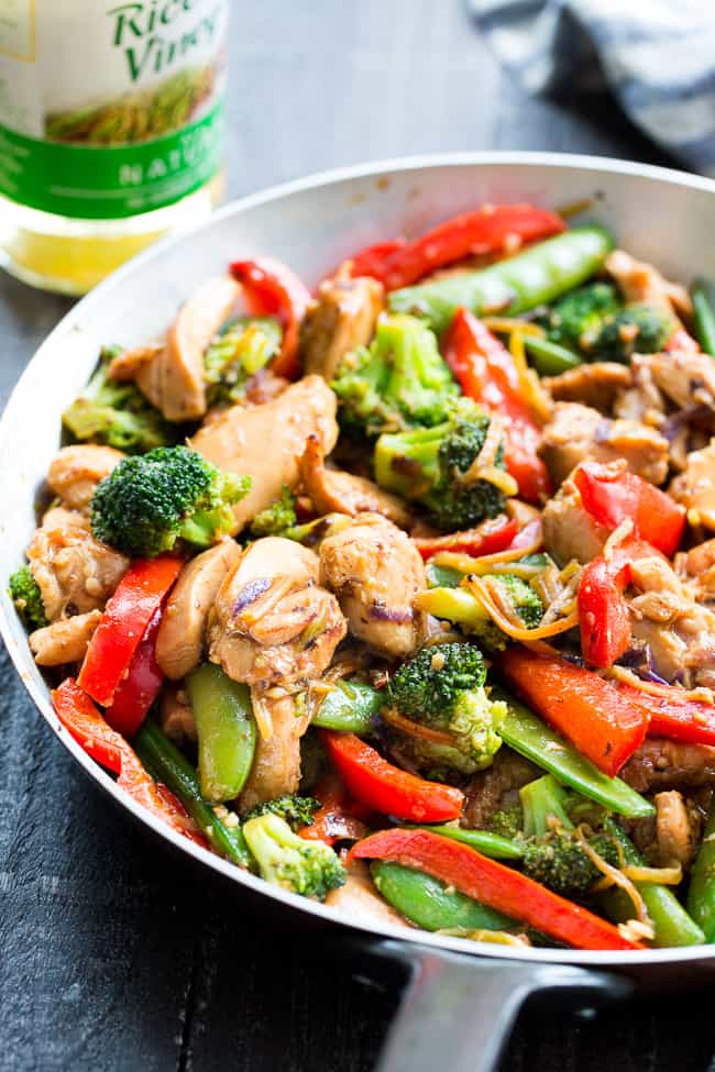 This easy chicken stir fry is better than takeout, so much healthier and quick to throw together for a weeknight dinner.  The garlic sauce is packed with flavor and made with Paleo and Whole30 friendly ingredients.  Delicious served alone or over fried cauliflower rice, kid approved and packed with veggies!