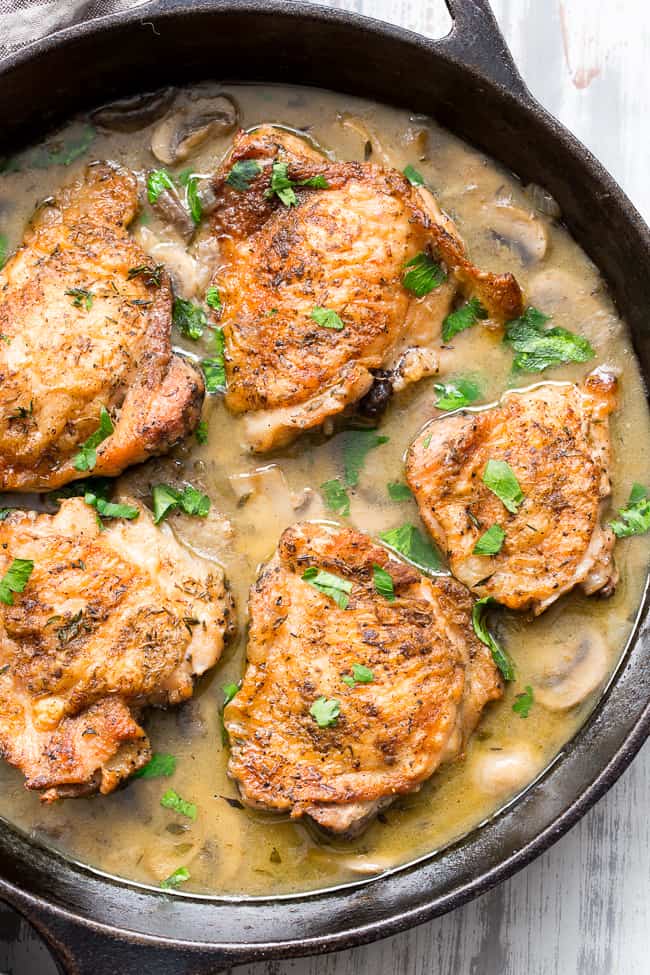 This crispy paleo chicken with creamy mushroom sauce is made all in one pan, packed with flavor, dairy free, paleo, keto and Whole30 compliant!  Seasoned crispy skinned chicken thighs with a dairy free mushroom sauce that's perfect over cauliflower rice or with roasted and veggies.