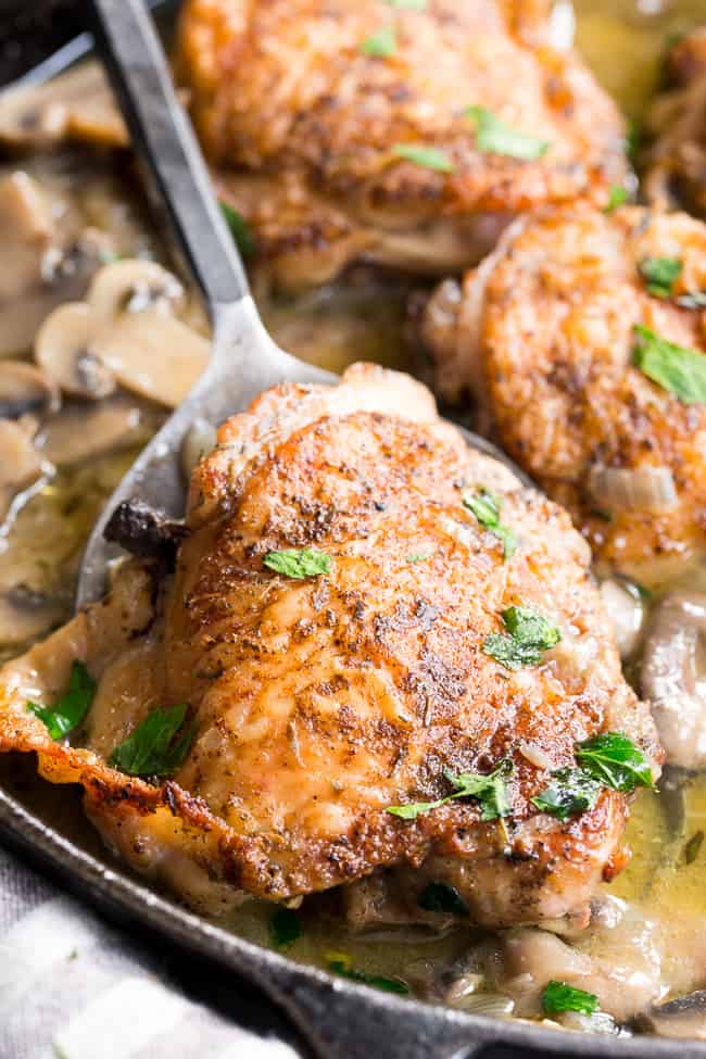 This creamy chicken with mushrooms is made all in one pan, packed with flavor, dairy free, paleo, keto and Whole30 compliant!  Seasoned crispy skinned chicken thighs with a dairy free mushroom sauce that's perfect over cauliflower rice or with roasted and veggies.