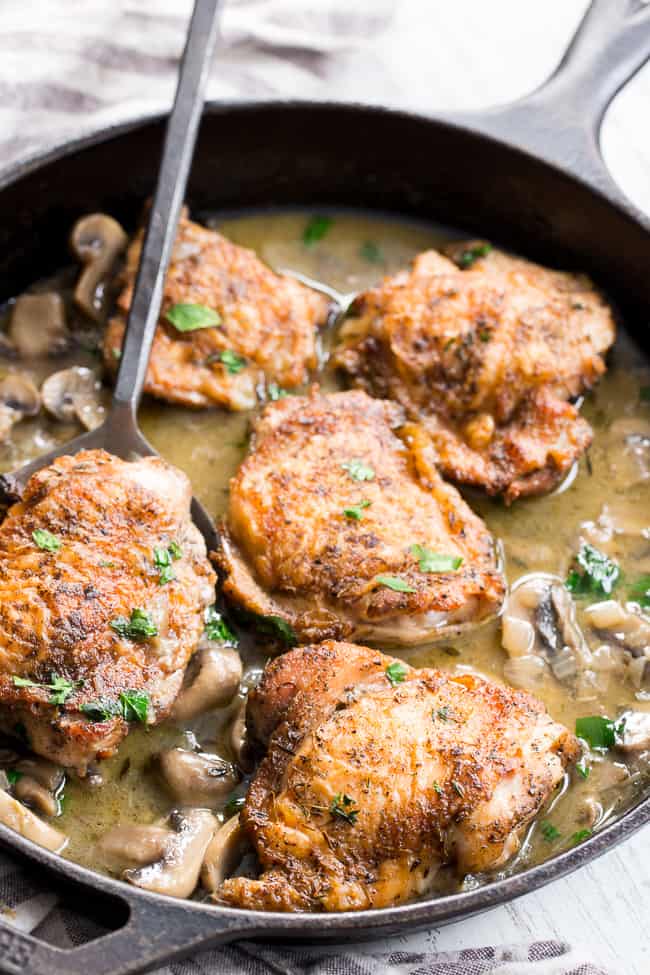 This creamy chicken with mushrooms is made all in one pan, packed with flavor, dairy free, paleo, keto and Whole30 compliant!  Seasoned crispy skinned chicken thighs with a dairy free mushroom sauce that's perfect over cauliflower rice or with roasted and veggies.