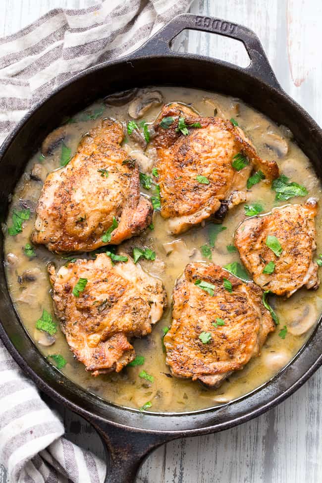 This creamy chicken with mushrooms is made all in one pan, packed with flavor, dairy free, paleo, keto and Whole30 compliant!  Seasoned crispy skinned chicken thighs with a dairy free mushroom sauce that's perfect over cauliflower rice or with roasted and veggies.