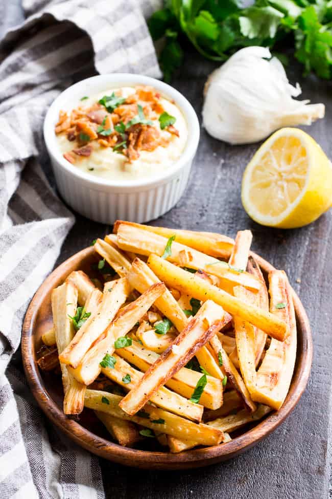 These crispy baked garlic parsnip fries are easy and totally tasty with any main dish!  Lower in carbs than potato fries and packed with flavor, with a creamy, tangy, bacon aioli for dipping.  Kid approved, Paleo and Whole30 compliant, perfect side dish or appetizer.