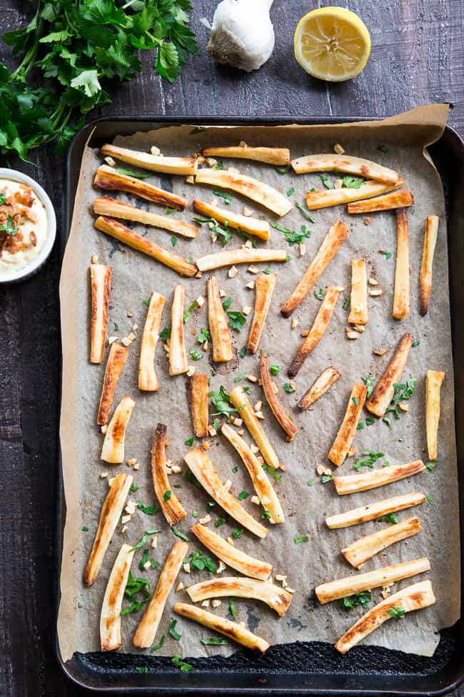 These crispy baked garlic parsnip fries are easy and totally tasty with any main dish!  Lower in carbs than potato fries and packed with flavor, with a creamy, tangy, bacon aioli for dipping.  Kid approved, Paleo and Whole30 compliant, perfect side dish or appetizer.