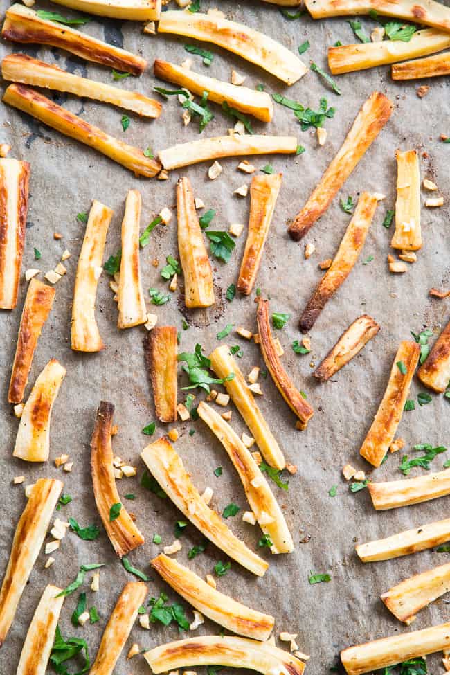 These crispy baked garlic parsnip fries are easy and totally tasty with any main dish!  Lower in carbs than potato fries and packed with flavor, with a creamy, tangy, bacon aioli for dipping.  Kid approved, Paleo and Whole30 compliant, perfect side dish or appetizer.