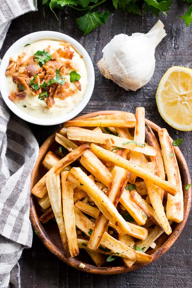 These crispy baked garlic parsnip fries are easy and totally tasty with any main dish!  Lower in carbs than potato fries and packed with flavor, with a creamy, tangy, bacon aioli for dipping.  Kid approved, Paleo and Whole30 compliant, perfect side dish or appetizer.