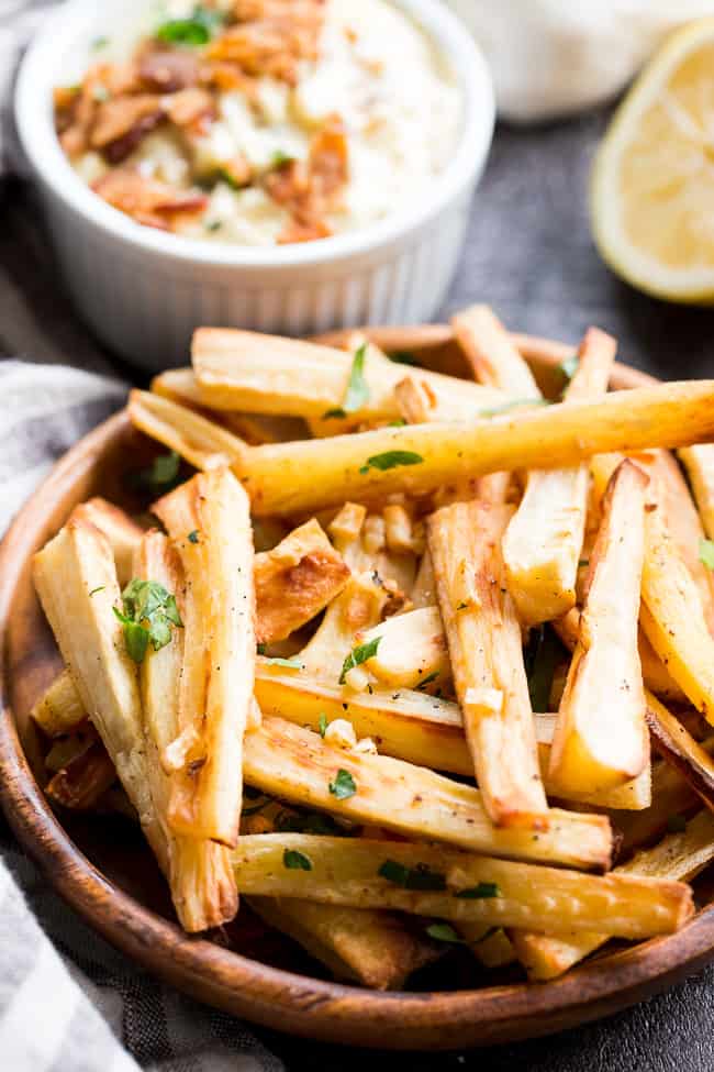 These crispy baked garlic parsnip fries are easy and totally tasty with any main dish!  Lower in carbs than potato fries and packed with flavor, with a creamy, tangy, bacon aioli for dipping.  Kid approved, Paleo and Whole30 compliant, perfect side dish or appetizer.