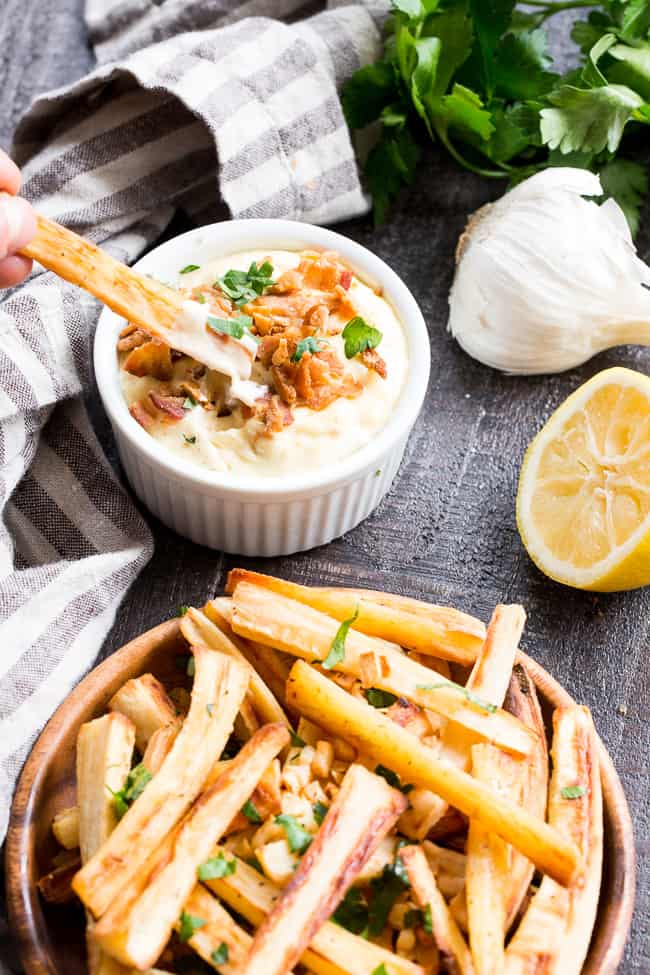 These crispy baked garlic parsnip fries are easy and totally tasty with any main dish!  Lower in carbs than potato fries and packed with flavor, with a creamy, tangy, bacon aioli for dipping.  Kid approved, Paleo and Whole30 compliant, perfect side dish or appetizer.