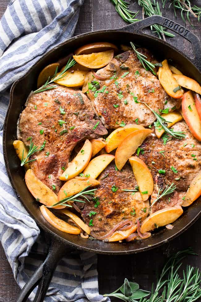 One-skillet pork chops with apples features seasoned, savory juicy pork chops with sweet apples simmered to perfection! This Paleo and Whole30 compliant dinner is easy, fast and great for weeknights!  Serve as is or with cauliflower rice, roasted sweet potatoes or a green salad.