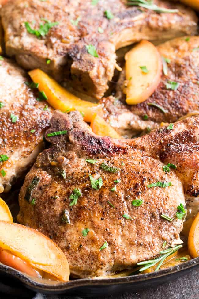 One-skillet pork chops with apples features seasoned, savory juicy pork chops with sweet apples simmered to perfection! This Paleo and Whole30 compliant dinner is easy, fast and great for weeknights!  Serve as is or with cauliflower rice, roasted sweet potatoes or a green salad.