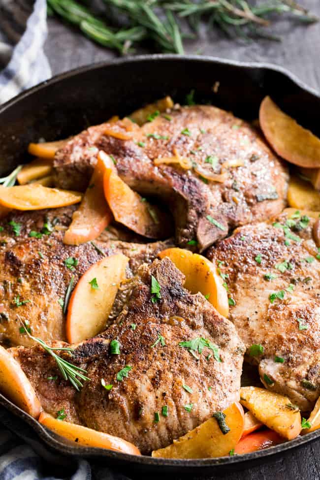 One-skillet pork chops with apples features seasoned, savory juicy pork chops with sweet apples simmered to perfection! This Paleo and Whole30 compliant dinner is easy, fast and great for weeknights!  Serve as is or with cauliflower rice, roasted sweet potatoes or a green salad.