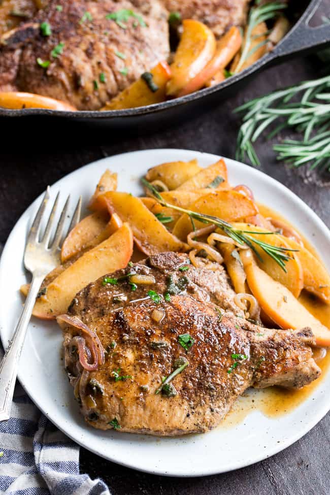 One-skillet pork chops with apples features seasoned, savory juicy pork chops with sweet apples simmered to perfection! This Paleo and Whole30 compliant dinner is easy, fast and great for weeknights!  Serve as is or with cauliflower rice, roasted sweet potatoes or a green salad.
