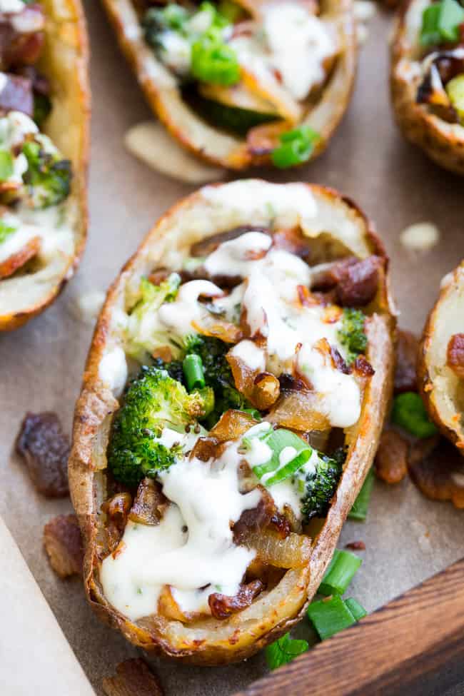 Yes - you can have crispy loaded potato skins while keeping things Whole30 and Paleo!  These crispy baked skins are loaded with roasted broccoli, caramelized onions, crisp bacon and drizzled all over with homemade ranch for tons of flavor with no dairy in sight.  Great as an appetizer or side dish, kid approved, easy to make!