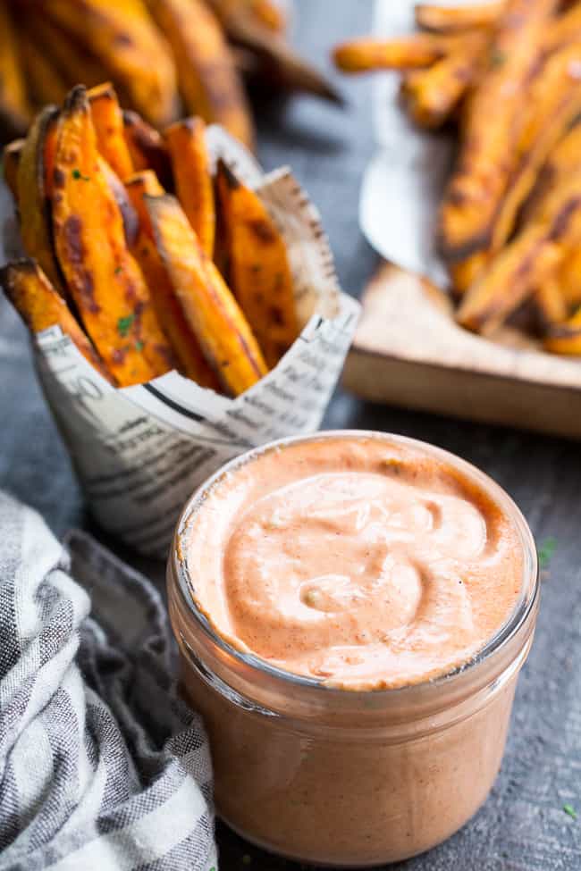 Crispy baked paleo and Whole30 compliant sweet potato fries are not only possible, but easy to make, too!  Served here with an insanely tasty, Whole30 compliant BBQ ranch dip that you'll want to put on everything.  Kid approved, great for a fun snack, side dish, or appetizer any time!