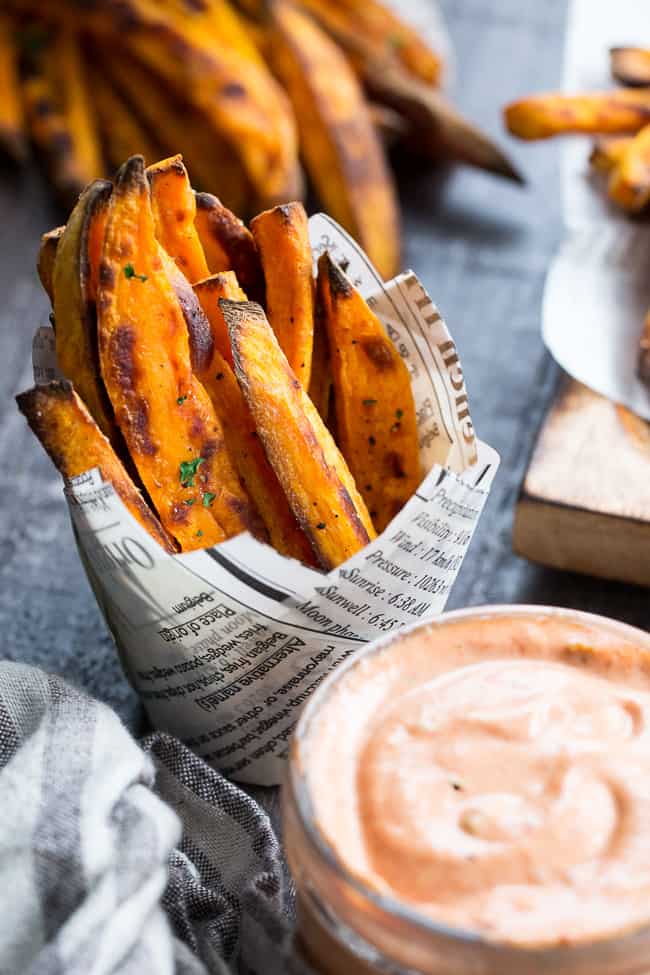 Crispy baked paleo and Whole30 compliant sweet potato fries are not only possible, but easy to make, too!  Served here with an insanely tasty, Whole30 compliant BBQ ranch dip that you'll want to put on everything.  Kid approved, great for a fun snack, side dish, or appetizer any time!