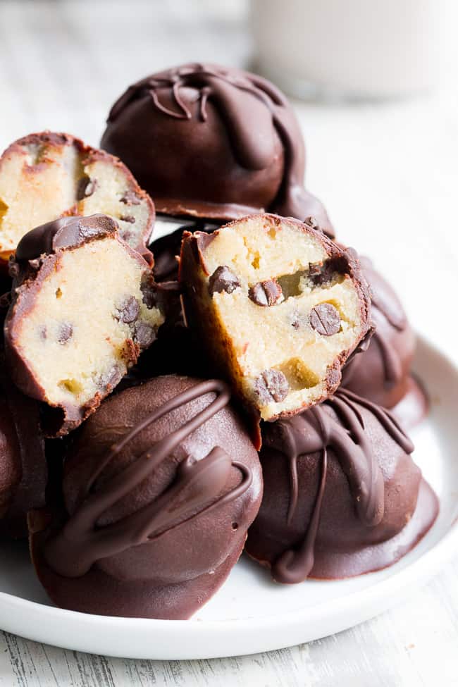 These chocolate chip cookie dough truffles taste decadent but are paleo, vegan and made with clean ingredients!  A grain free, dairy free, edible chocolate chip cookie dough is dipped in an easy homemade dark chocolate for a dessert that everyone will go wild for!