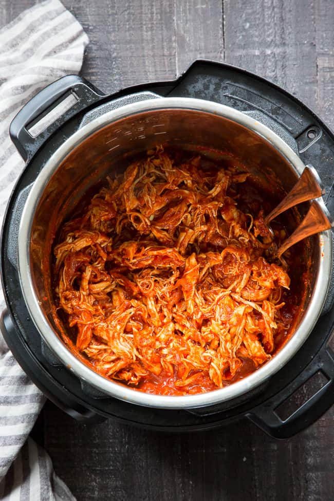 This simple Paleo and Whole30 Instant Pot BBQ Chicken is packed with flavor and perfect over a sweet potato or your favorite greens!  An easy homemade BBQ sauce is cooked right in with the chicken for a meal that's ready in 20 minutes - perfect for weeknights and family approved!