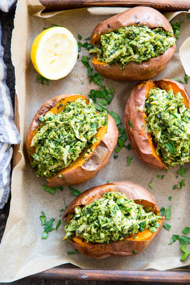 These chicken pesto stuffed sweet potatoes are seriously tasty, filling and easy to make!  A paleo and Whole30 compliant pesto is mixed with shredded chicken and tops perfectly baked sweet potatoes.  Great to make ahead of time and the leftovers save well!