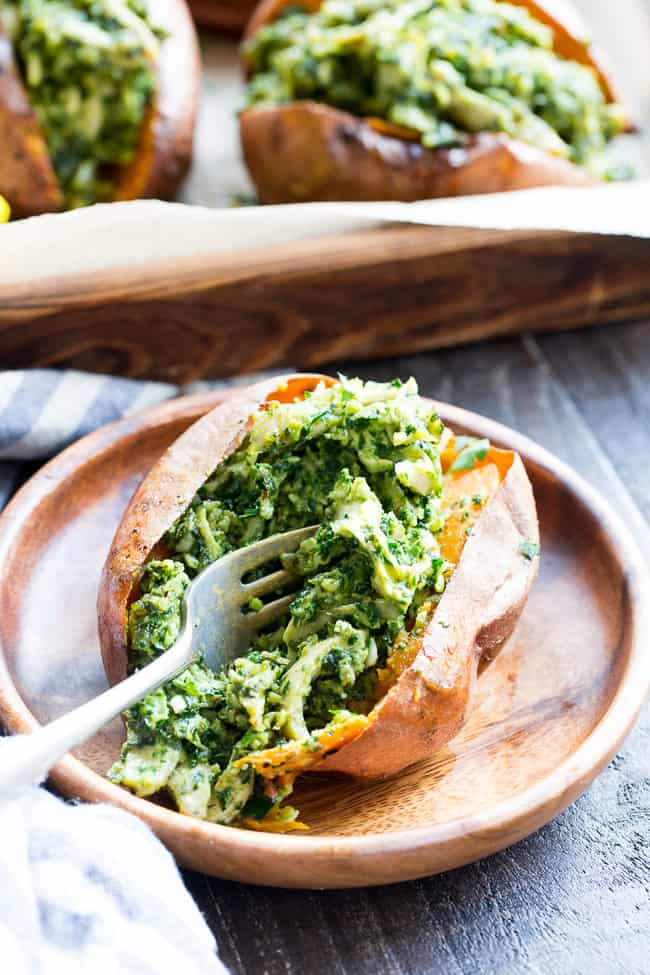 These chicken pesto stuffed sweet potatoes are seriously tasty, filling and easy to make!  A paleo and Whole30 compliant pesto is mixed with shredded chicken and tops perfectly baked sweet potatoes.