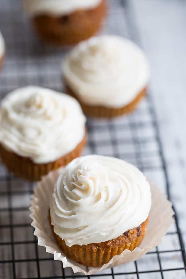 These dreamy carrot cake cupcakes are made with coconut and tapioca flour and sweetened with maple syrup, making them both paleo and nut free.   They're topped with a sweet creamy paleo vanilla "buttercream" that tastes just like real thing! 