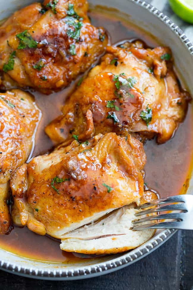 This garlic chipotle lime chicken is packed with tons of flavor and is incredibly easy to make in the Instant Pot!  The chicken is seared and pressure cooked in spicy/sweet sauce for a result that's sure to make everyone in your family happy!  Healthy, hearty, paleo friendly with a Whole30 option. 