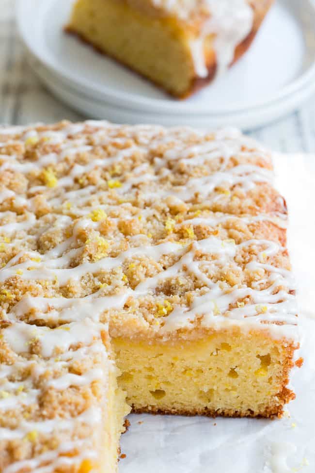 This amazing paleo lemon crumb cake is deliciously sweet/tart and bursting with fresh lemon flavor!  It starts with a  perfectly moist lemon cake layer, topped with lemon curd, piled with crumb topping and drizzled with lemon glaze.  It's gluten-free, dairy-free, paleo will become a favorite dessert with the first bite!