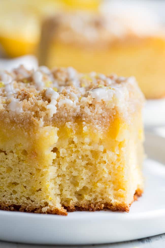 This amazing paleo lemon crumb cake is deliciously sweet/tart and bursting with fresh lemon flavor!  It starts with a  perfectly moist lemon cake layer, topped with lemon curd, piled with crumb topping and drizzled with lemon glaze.  It's gluten-free, dairy-free, paleo will become a favorite dessert with the first bite!