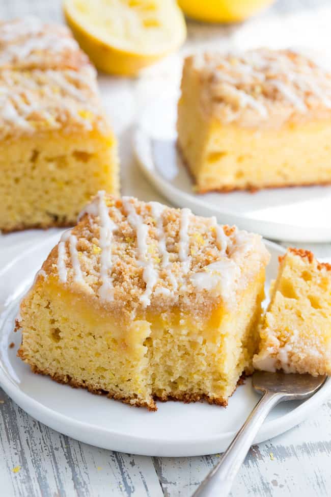 This amazing paleo lemon crumb cake is deliciously sweet/tart and bursting with fresh lemon flavor!  It starts with a  perfectly moist lemon cake layer, topped with lemon curd, piled with crumb topping and drizzled with lemon glaze.  It's gluten-free, dairy-free, paleo will become a favorite dessert with the first bite!