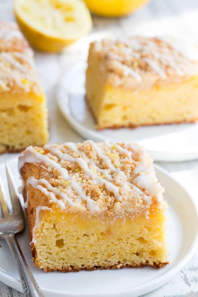 This amazing paleo lemon crumb cake is deliciously sweet/tart and bursting with fresh lemon flavor!  It starts with a  perfectly moist lemon cake layer, topped with lemon curd, piled with crumb topping and drizzled with lemon glaze.  It's gluten-free, dairy-free, paleo will become a favorite dessert with the first bite!