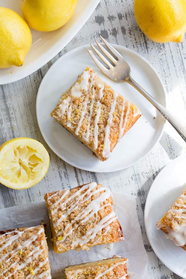 This amazing paleo lemon crumb cake is deliciously sweet/tart and bursting with fresh lemon flavor!  It starts with a  perfectly moist lemon cake layer, topped with lemon curd, piled with crumb topping and drizzled with lemon glaze.  It's gluten-free, dairy-free, paleo will become a favorite dessert with the first bite!
