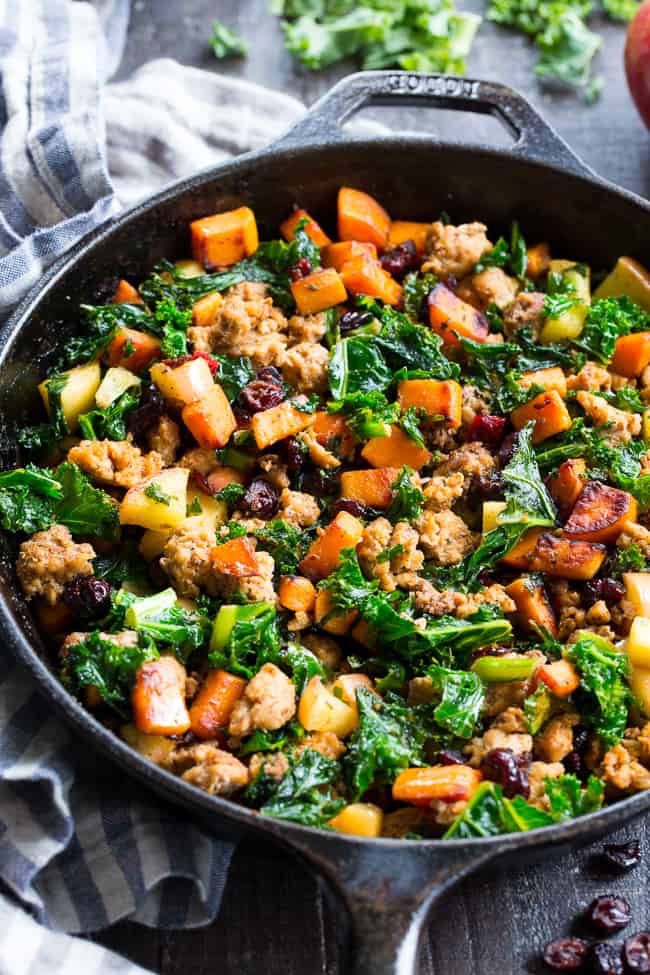 This sweet potato paleo breakfast hash is loaded with flavor, filling, nourishing, with the perfect sweet/savory balance.   Pan fried sweet potatoes are cooked with seasoned ground meat, greens, apples and cranberries for a delicious Whole30 and Paleo breakfast without the eggs! 