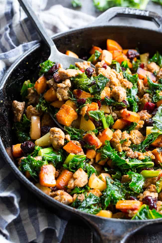 This sweet potato paleo breakfast hash is loaded with flavor, filling, nourishing, with the perfect sweet/savory balance.   Pan fried sweet potatoes are cooked with seasoned ground meat, greens, apples and cranberries for a delicious Whole30 and Paleo breakfast without the eggs! 