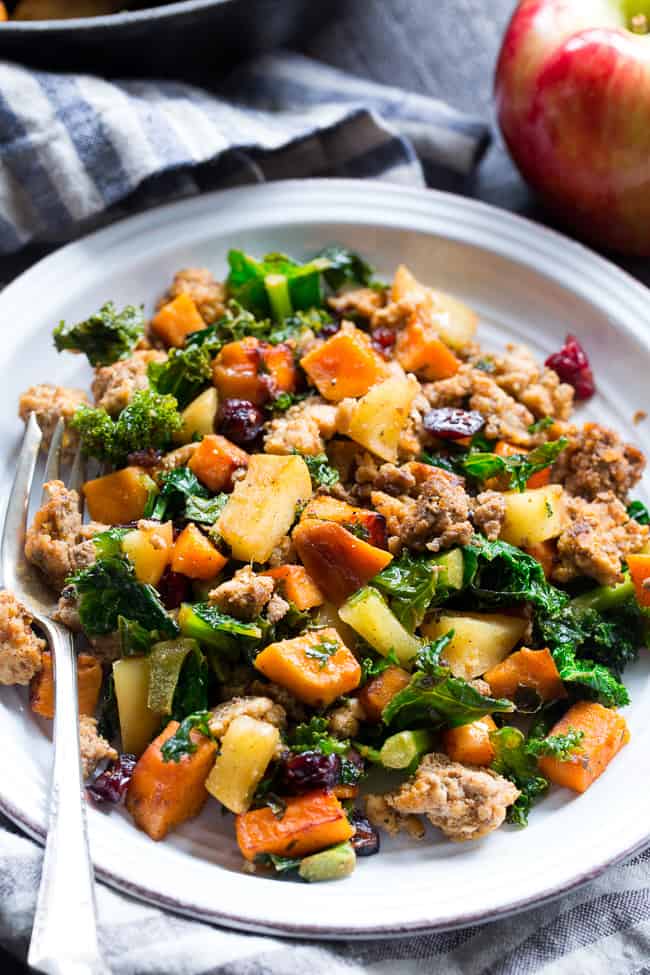 This sweet potato paleo breakfast hash is loaded with flavor, filling, nourishing, with the perfect sweet/savory balance.   Pan fried sweet potatoes are cooked with seasoned ground meat, greens, apples and cranberries for a delicious Whole30 and Paleo breakfast without the eggs! 