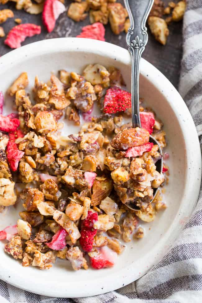 This crunchy grain free granola is packed with toasty sweet clusters and freeze dried strawberries for a breakfast or snack that you won't believe is actually good for you!  It's paleo, vegan, free of refined sugar and family approved!