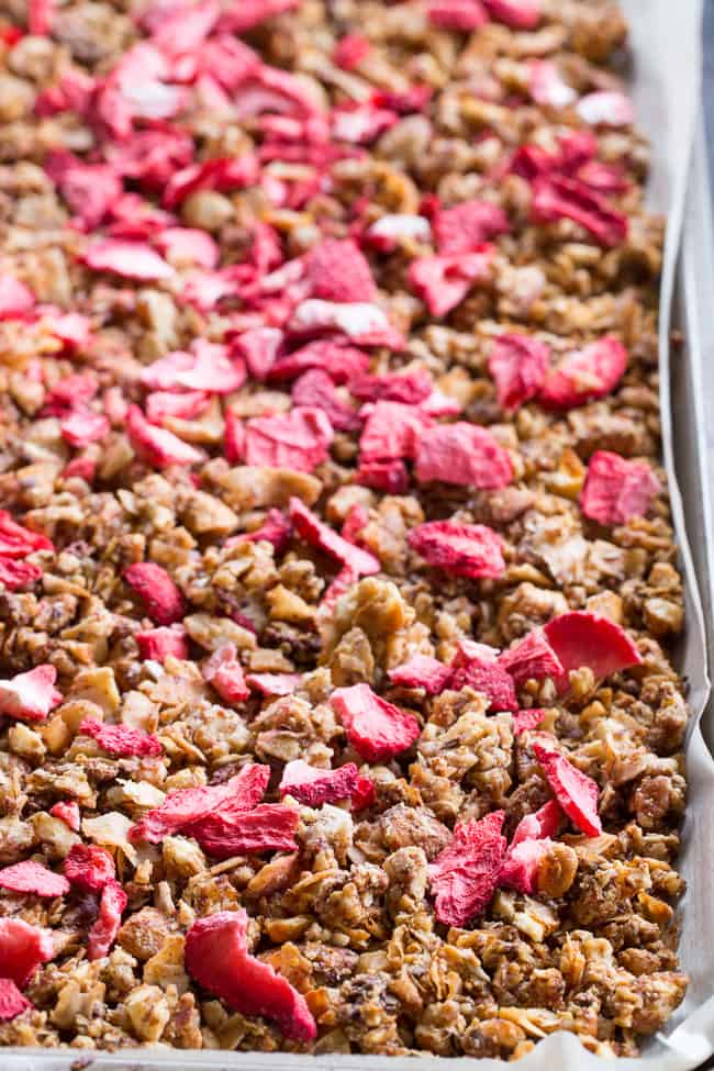 This crunchy grain free granola is packed with toasty sweet clusters and freeze dried strawberries for a breakfast or snack that you won't believe is actually good for you!  It's paleo, vegan, free of refined sugar and family approved!