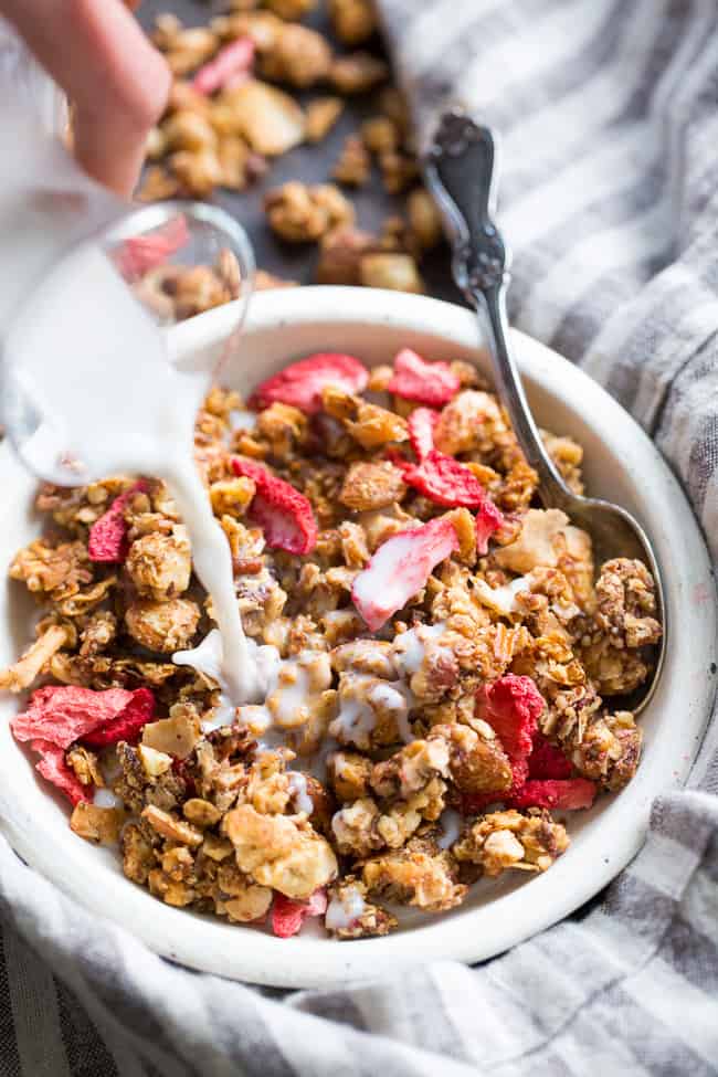 This crunchy grain free granola is packed with toasty sweet clusters and freeze dried strawberries for a breakfast or snack that you won't believe is actually good for you!  It's paleo, vegan, free of refined sugar and family approved!