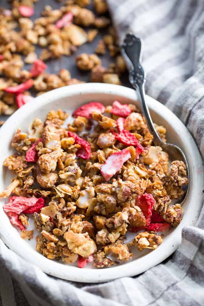 This crunchy grain free granola is packed with toasty sweet clusters and freeze dried strawberries for a breakfast or snack that you won't believe is actually good for you!  It's paleo, vegan, free of refined sugar and family approved!
