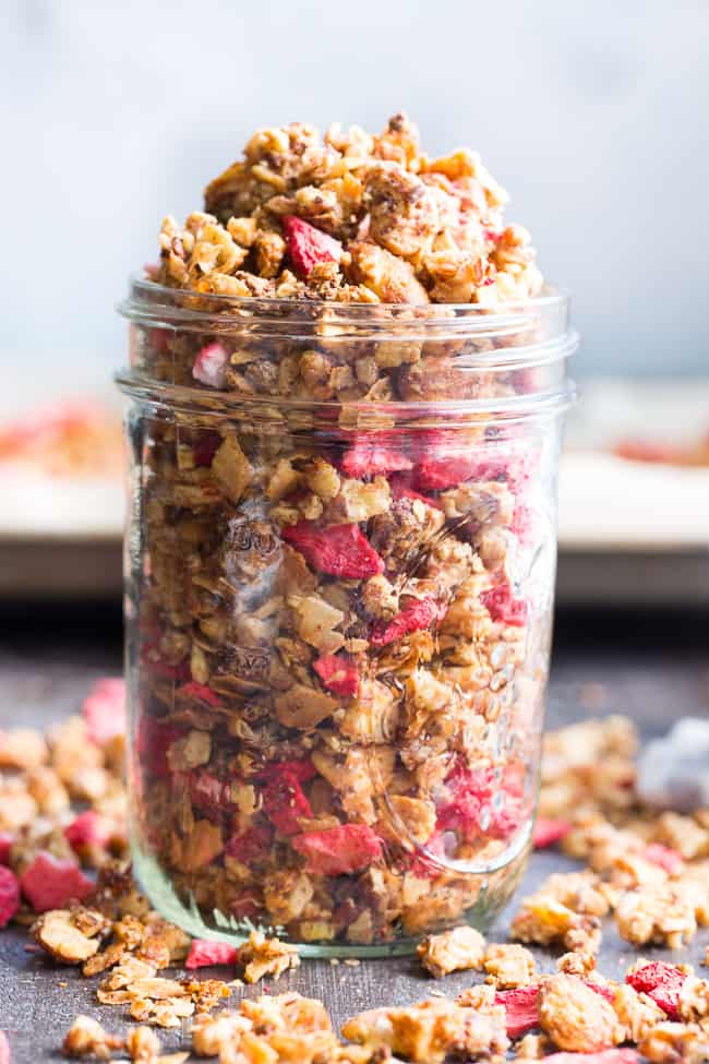 This crunchy grain free granola is packed with toasty sweet clusters and freeze dried strawberries for a breakfast or snack that you won't believe is actually good for you!  It's paleo, vegan, free of refined sugar and family approved!