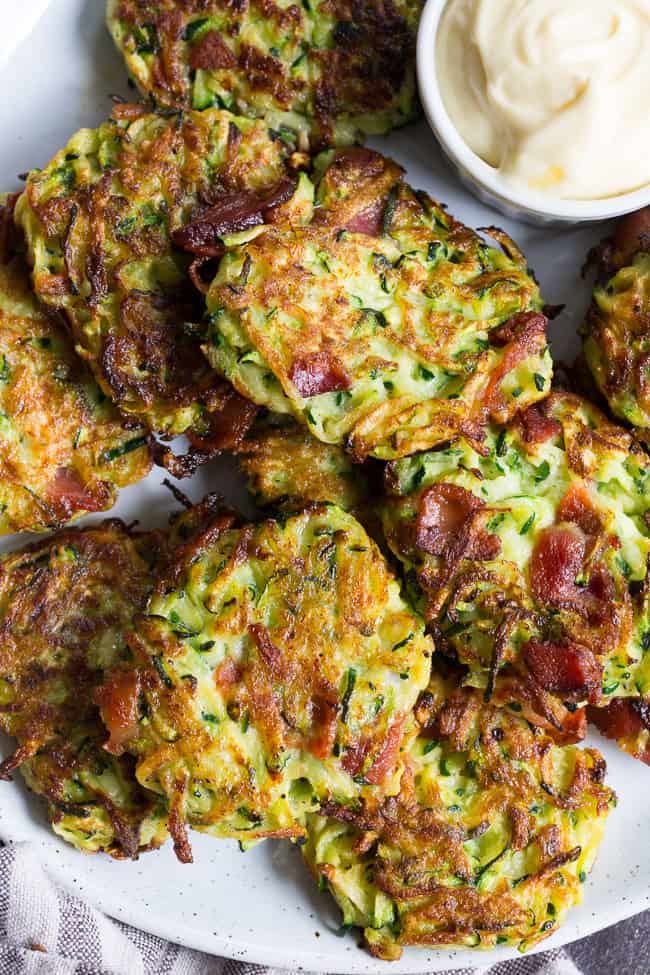 These savory bacon zucchini fritters are easy to make, packed with veggies and downright addicting!  They're delicious served as a side dish or appetizer with homemade ranch dip.  These tasty fritters are also paleo, Whole30 friendly, gluten free and dairy free.